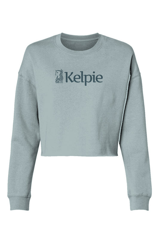 Sage colored paddle board crop crew sweater with a blue Kelpie logo.