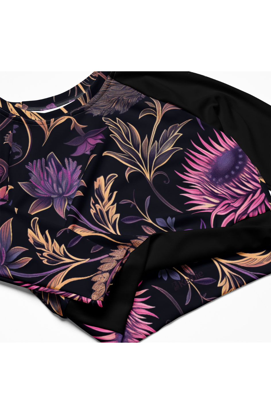 Kelpie long sleeve crop-top rash guard with a thistle pattern on the torso.