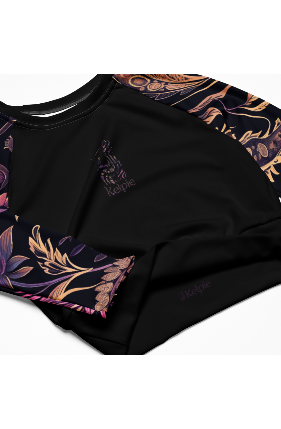 Kelpie long sleeve crop-top rash guard with a thistle pattern on the sleeves and a black torso.